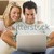 Couple in living room using laptop smiling stock photo © monkey_business