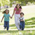 Woman with two young children running outdoors smiling stock photo © monkey_business
