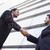 Two businessmen shaking hands outside office building stock photo © monkey_business