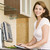 Woman in kitchen with computer smiling stock photo © monkey_business