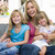Woman and two young girls sitting on patio smiling stock photo © monkey_business