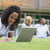 jeune · femme · utilisant · un · ordinateur · portable · campus · pelouse · autre · élèves - photo stock © monkey_business