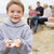 Family at beach with picnic smiling focus on boy with seashells stock photo © monkey_business