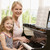 Woman and young girl playing piano and smiling stock photo © monkey_business
