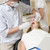 Dentist and assistant in exam room with woman in chair stock photo © monkey_business