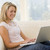 Woman in living room using laptop smiling stock photo © monkey_business
