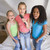 Three Young Girls Standing On A Bed, Singing Into A Hairbrush stock photo © monkey_business