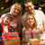 Family Opening Christmas Present In Front Of Tree stock photo © monkey_business