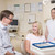 Dentist and assistant in exam room with woman in chair smiling stock photo © monkey_business
