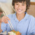 Young boy in dining room eating chinese food smiling stock photo © monkey_business