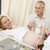Pregnant woman getting ultrasound from doctor with husband watch stock photo © monkey_business