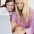 二人の女性 · パティオ · ラップトップを使用して · 笑みを浮かべて · コンピュータ · 女性 - ストックフォト © monkey_business