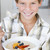 Young boy in kitchen eating oatmeal with fruit smiling stock photo © monkey_business