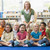 Kindergarten teacher sitting with children in library stock photo © monkey_business