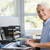 Man in home office using computer smiling stock photo © monkey_business