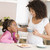 Woman and young girl in kitchen with cookies and coffee smiling stock photo © monkey_business