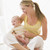 Mother and baby sitting indoors smiling stock photo © monkey_business