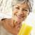 starszy · uśmiechnięta · kobieta · kamery · pitnej · sok · pomarańczowy · kobieta - zdjęcia stock © monkey_business