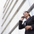 女性実業家 · 話し · 携帯電話 · 外 · 現代 · オフィスビル - ストックフォト © monkey_business