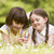 Two sisters lying outdoors with flower smiling stock photo © monkey_business