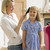 Woman in front hallway brushing young girl's hair and smiling stock photo © monkey_business