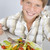 Young boy in kitchen eating salad smiling stock photo © monkey_business