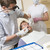 Dentist and assistant in exam room with man in chair stock photo © monkey_business