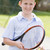 Young boy with racket on tennis court smiling stock photo © monkey_business
