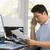 Man in home office with computer and paperwork on telephone stock photo © monkey_business