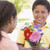 Young boy giving young girl flowers and smiling stock photo © monkey_business