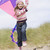 fiatal · lány · tengerpart · papírsárkány · mosolyog · gyermek · tél - stock fotó © monkey_business