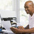 Man in home office using computer and smiling stock photo © monkey_business
