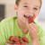 Young boy eating strawberries in living room smiling stock photo © monkey_business