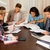 Multi ethnic group of students preparing for exams in home interior behind table  stock photo © Nejron