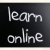 'Learn online' handwritten with white chalk on a blackboard stock photo © nenovbrothers