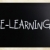 'E-learning' handwritten with white chalk on a blackboard stock photo © nenovbrothers
