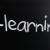 The word 'E-learning' handwritten with white chalk on a blackboa stock photo © nenovbrothers