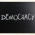 The word 'Democracy' handwritten with white chalk on a blackboar stock photo © nenovbrothers