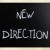 'New direction' handwritten with white chalk on a blackboard stock photo © nenovbrothers
