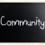 'Community' handwritten with white chalk on a blackboard stock photo © nenovbrothers