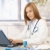 młodych · lekarza · zajęty · biuro · za · pomocą · laptopa · atrakcyjna · kobieta - zdjęcia stock © nyul