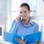 Smiling assistant on phone call holding folder stock photo © nyul