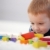 Adorable ginger-haired boy playing with cubes  stock photo © nyul