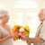 Senior man bringing flowers to wife stock photo © nyul
