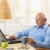 Elderly man using computer, having coffee stock photo © nyul