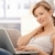 Happy young woman browsing internet at home stock photo © nyul
