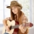 Attractive girl playing guitar in western hat stock photo © nyul