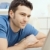 Young man using laptop at home stock photo © nyul