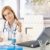 Attractive doctor writing report sitting at desk stock photo © nyul