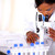 Medical doctor girl working with a microscope stock photo © pablocalvog